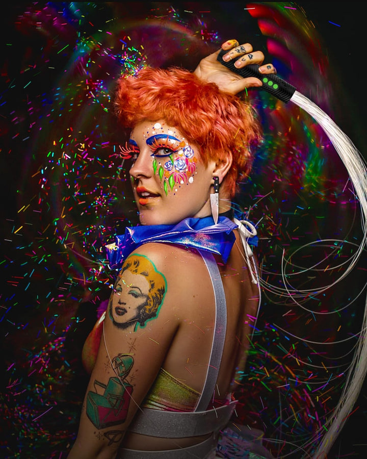 Performer with a glowing BitWhip and rainbow trails