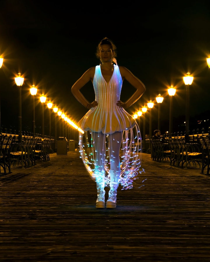 Glowing fiber optic dress on a boardwalk at night, by Natalie Walsh