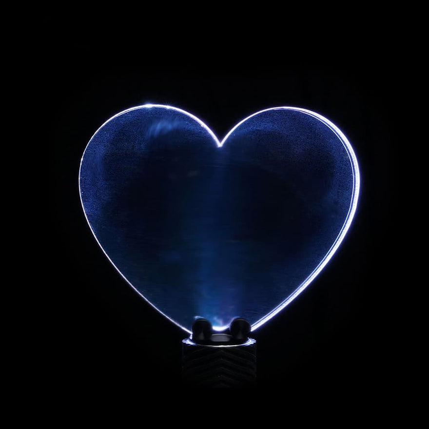 Heart-shaped acrylic light painting blade producing glowing romantic trails in long exposure photography