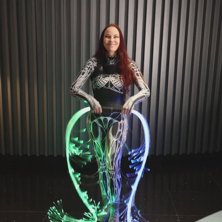 Video of a woman connecting two white BitWhips back to back using RGB Critter BT flashlights to form a Double BitWhip for festival flow arts performances.