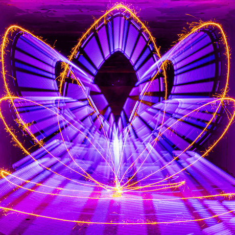 Light painting artwork combining purple trails and gold sparkler streaks made with the Sparkler Holder