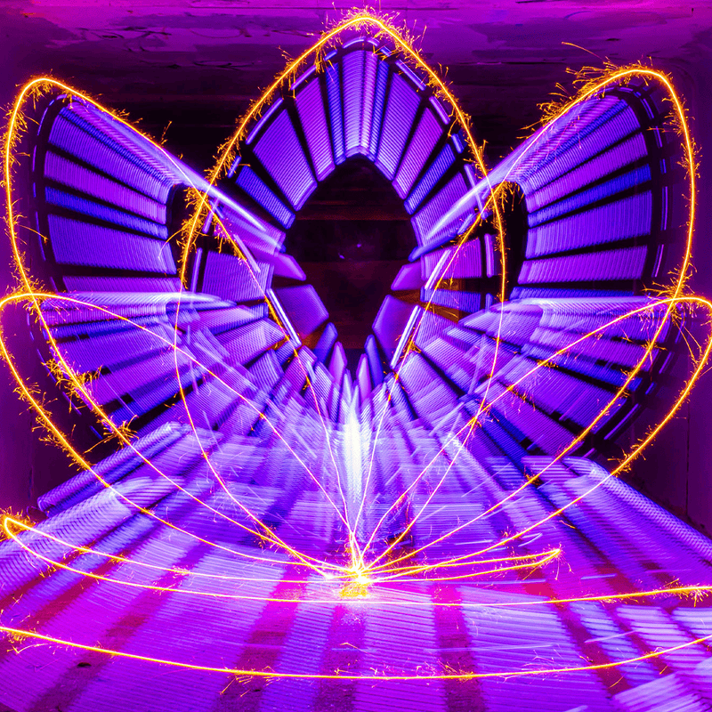 Purple light trails with gold sparkler streaks