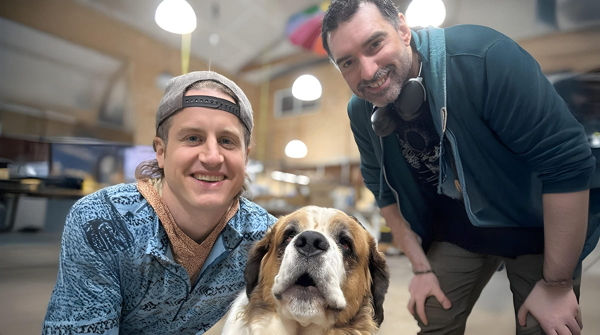 Joel and Toymaker Chris in the AOAM shop with a Saint Bernard