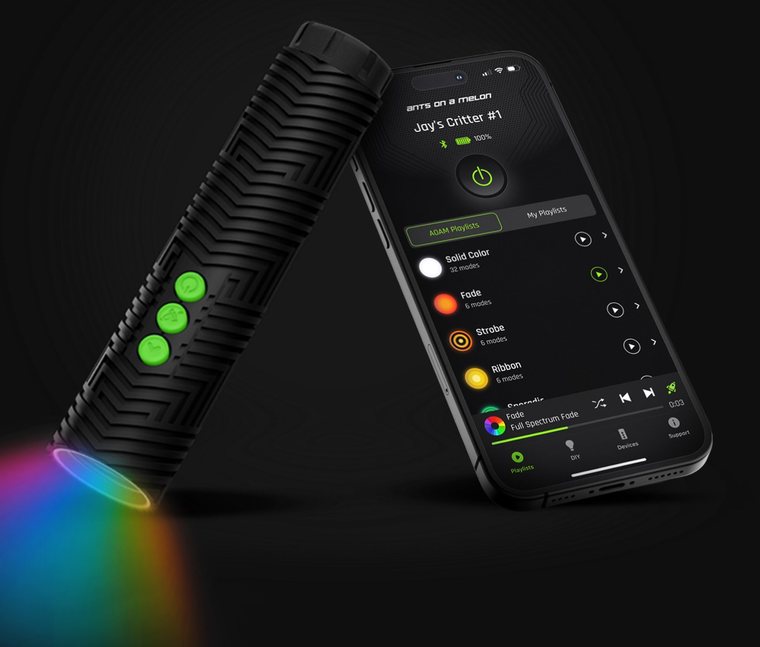 RGB Critter BT flashlight shining rainbow light beside the AOAM app