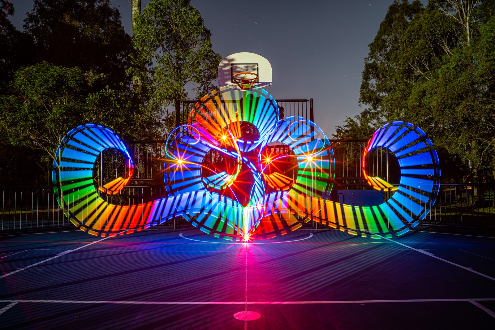 Layered multi-wheel light painting composition on a night court. Photo: Stephen Knight.