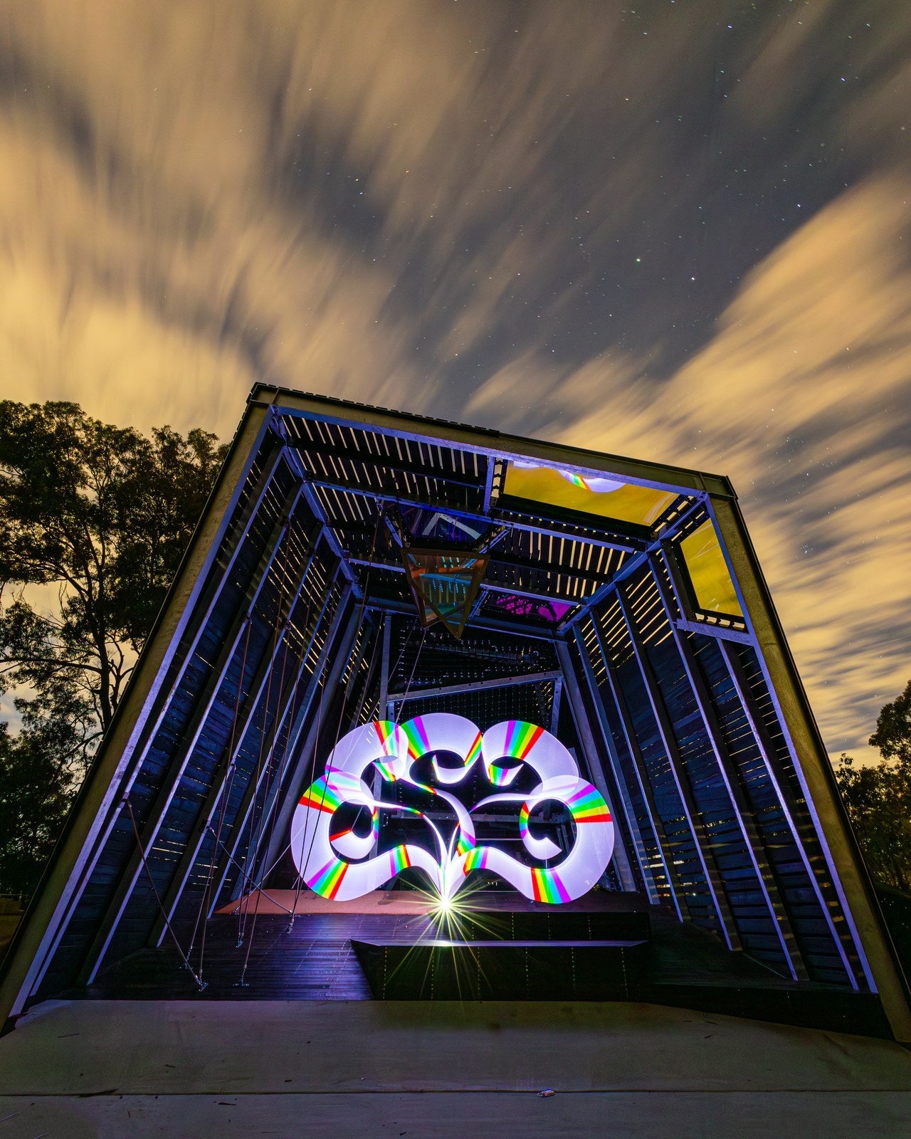 Light painting inside a timber art tower under night clouds. Photo: Stephen Knight.