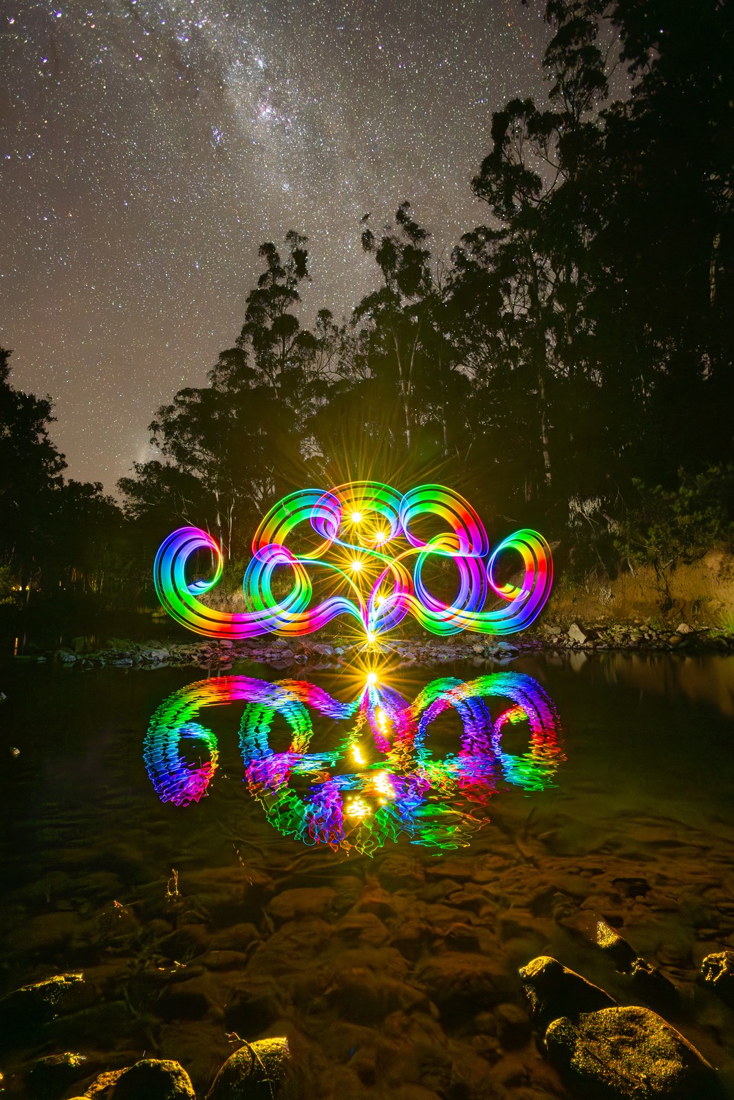 Rainbow light painting orb reflected in a creek beneath the Milky Way. Photo: Stephen Knight.