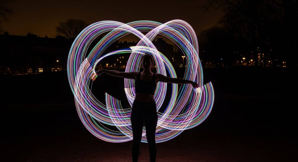 Fiber optic whip spinning glowing light trails at night