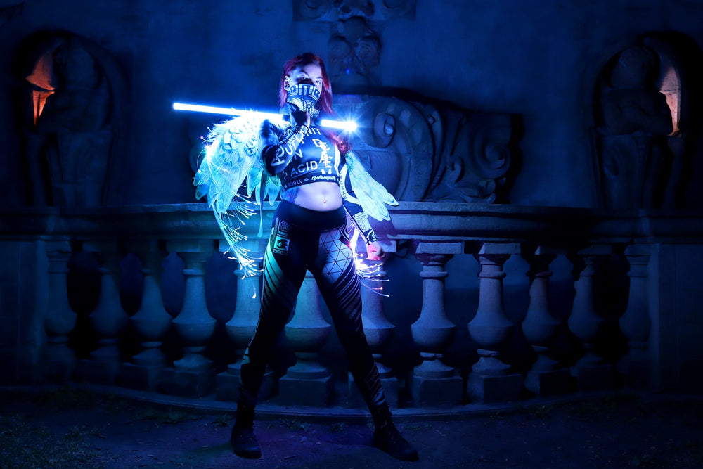Performer mid-flow with lit props at night