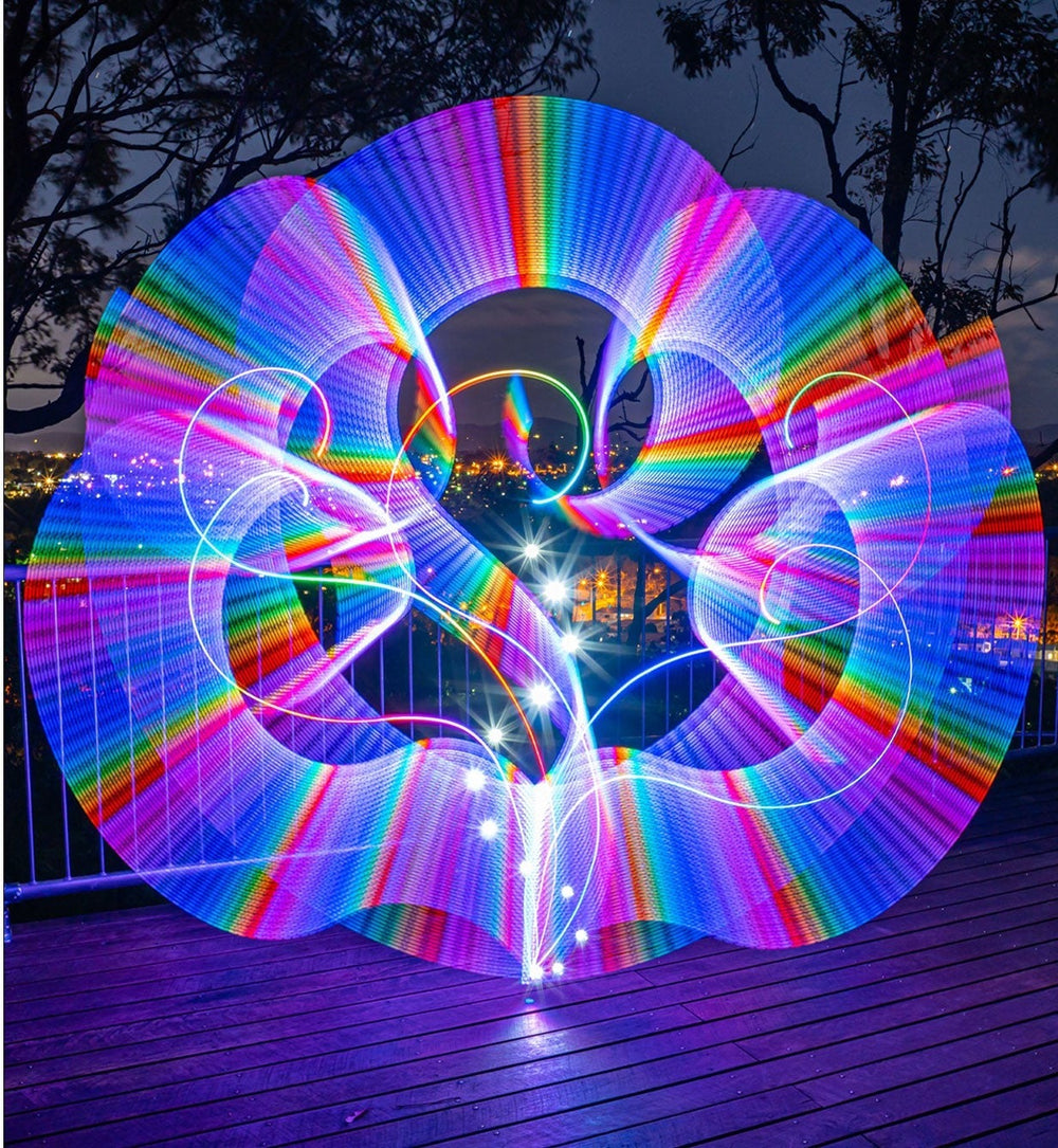 Rainbow light orb light painting photographed on a deck at night