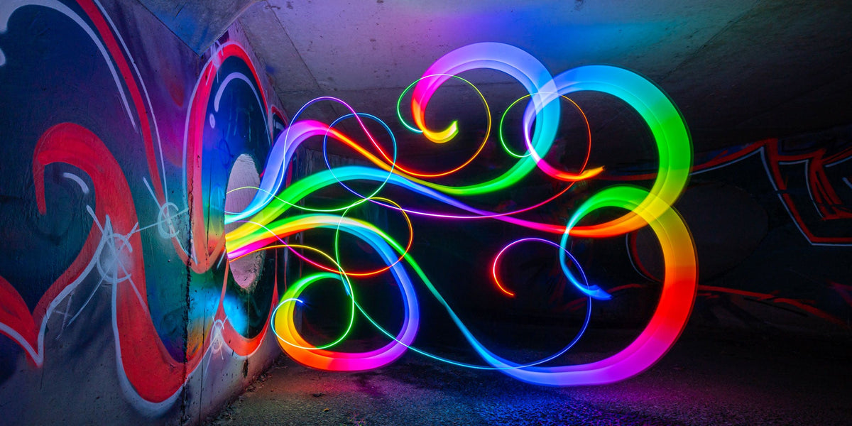 Rainbow light painted swirls in a graffiti tunnel, photo by Stephen Knight