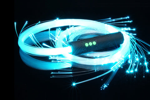 BitWhip fiber optic whip glowing light blue, coiled on a black surface