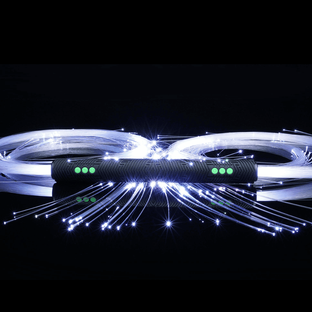 Double-sided BitWhip: one RGB Critter BT handle with a bundle of lit white fiber optic strands spraying from each end, on black