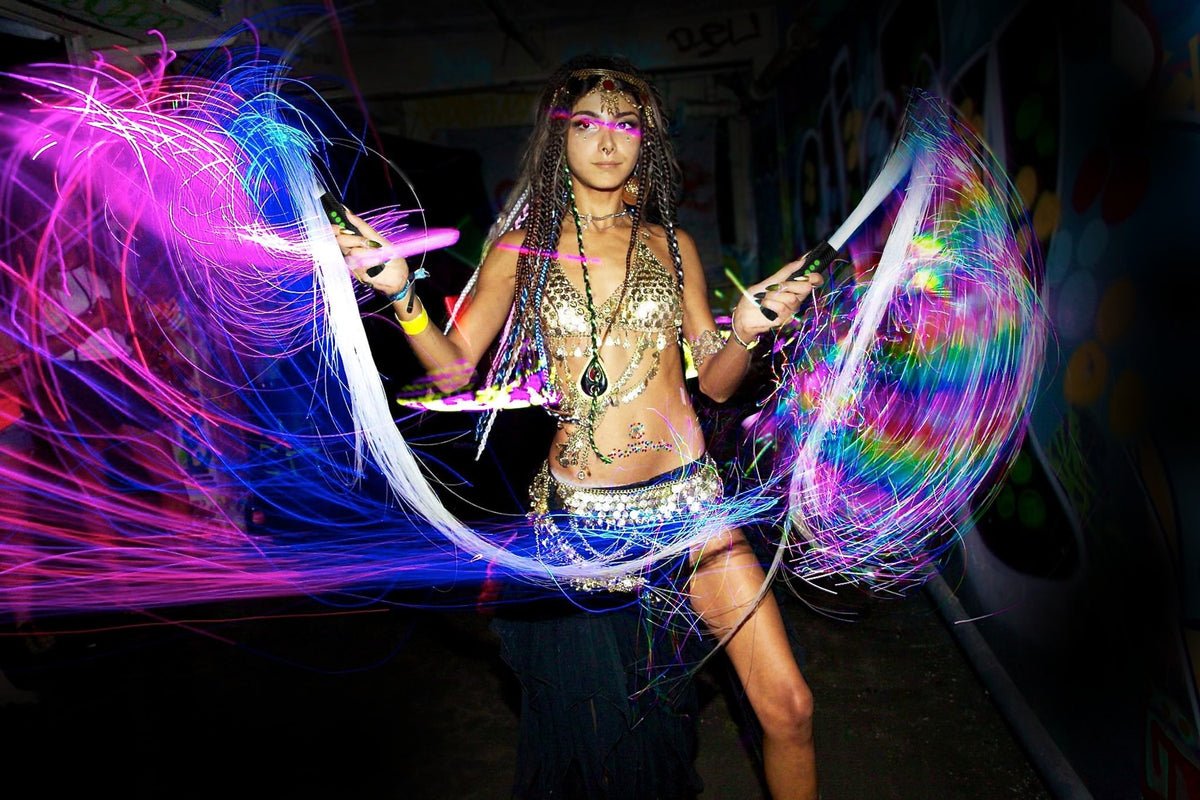 Performer spinning two BitWhips into rainbow light trails