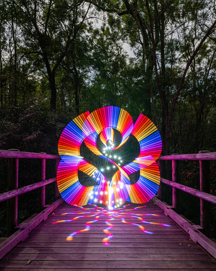 Long exposure light painting by Stephen Knight on a boardwalk in bands of color