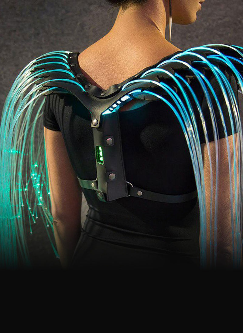 Fiber optic wing harness worn over the shoulders, glowing cyan strands falling either side