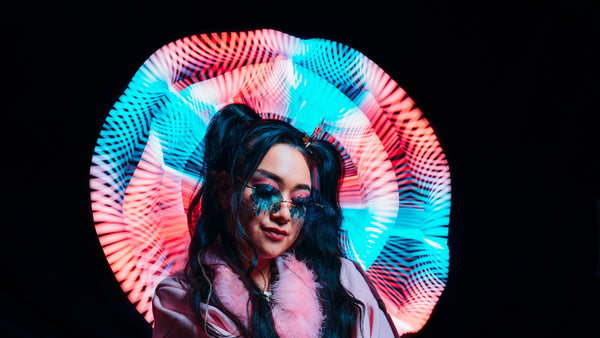 Light painting portrait with a glowing halo of red and cyan light behind the subject