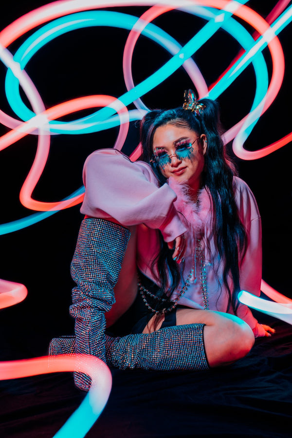 Light painting portrait wrapped in looping red and cyan light trails