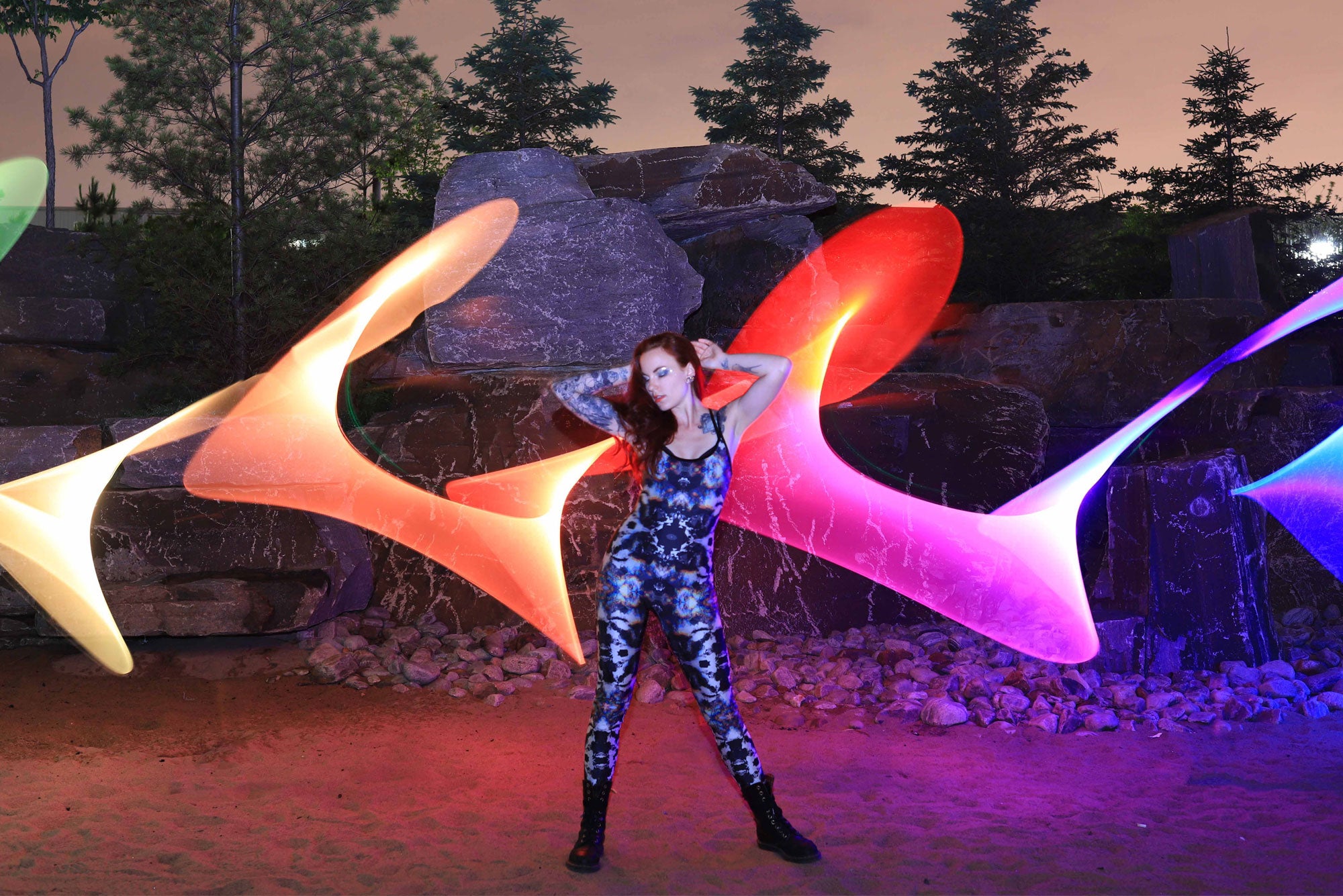 Light painting performance with rainbow light ribbons created with the RGB Critter