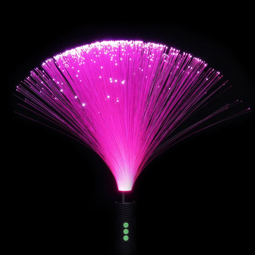 Glowing pink fiber optic Duster used in flow arts and light painting, ideal for creating dynamic visual effects and light trails at festivals like Burning Man.