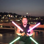 LED Staff spun on a bridge railing at dusk, light trails from both glowing ends