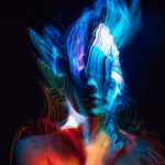 Light painting photograph featuring a woman as the model, illuminated by vibrant trails created using a black fiber optic duster for long exposure photography.